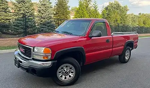 Red 1990s GMC Sierra pickup truck in pristine condition