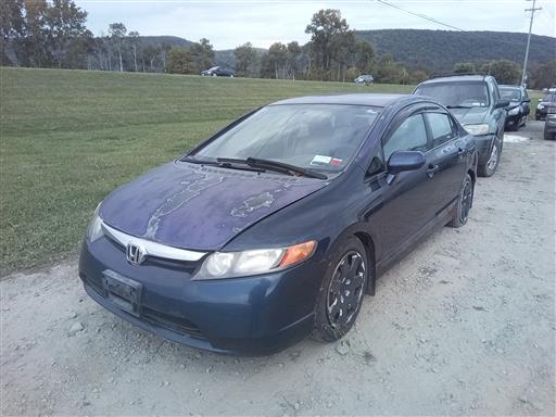 Blue Honda Civic with peeling paint on a gravel lot.