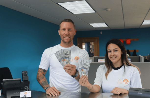 Two SMJC employees holding cash happily