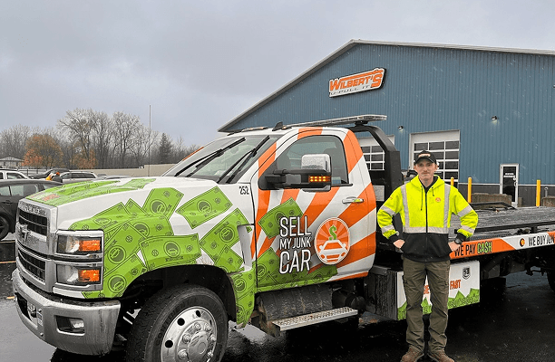 Coleton standing in front of SMJC tow truck